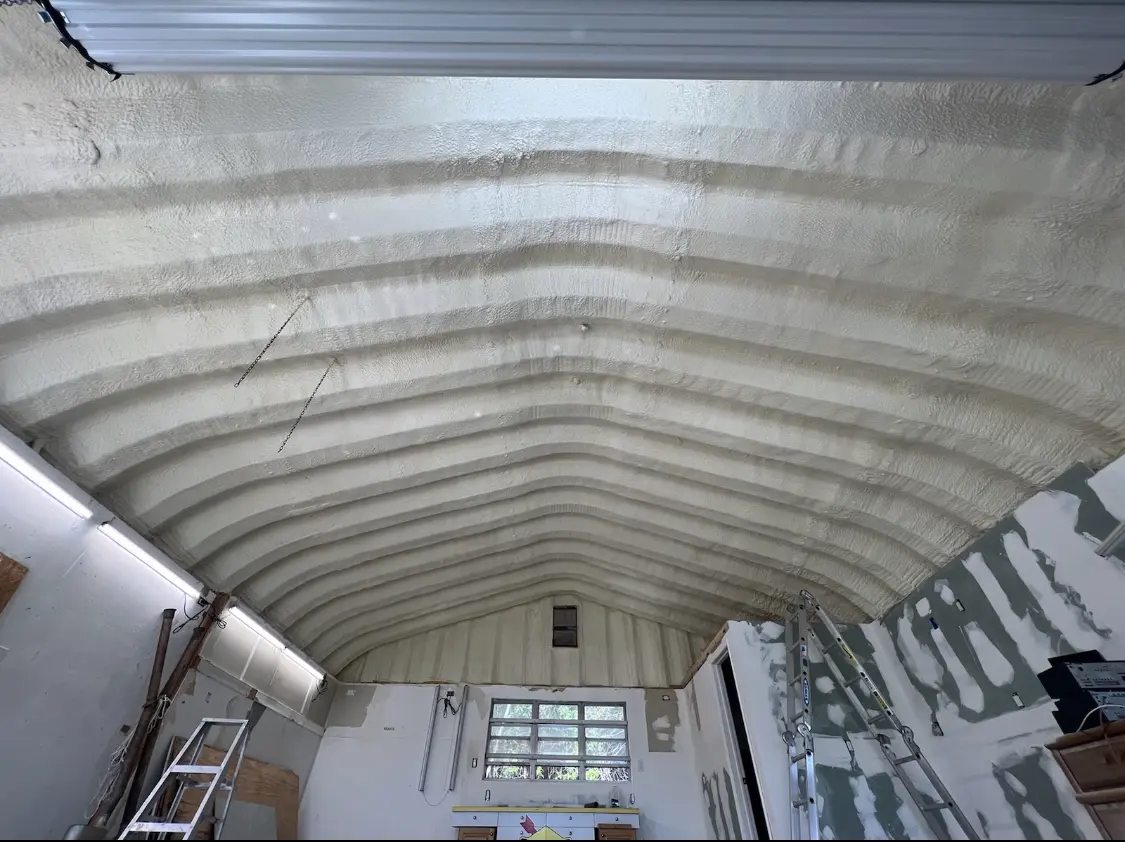 Spray polyurethane foam applied to the underside of a metal roof deck in Roosevelt